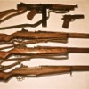 American Arsenal: Thompson submachine gun, M1911 pistol, and three M1 Garands